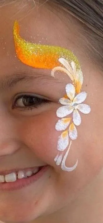 Close-up of golden rainbow face paint with white flowers and delicate white swirls beside the eye